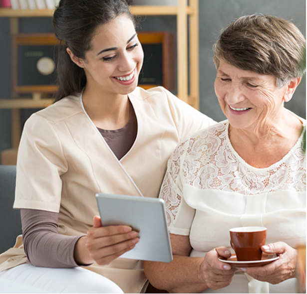 A promotional banner for ReliableRx Diabetes medication. The left side shows a tablet displaying the ReliableRx diabetes app interface, and the right side shows a lifestyle scene of a younger woman and an older woman smiling while looking at a tablet on a couch.